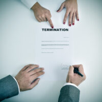 man signing a termination document