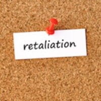 Retaliation. Word written on a piece of paper, cork board background. Retaliation. Word written on a piece of paper, cork board background.