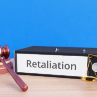 Retaliation – Folder with labeling, gavel and libra – law, judgement, lawyer