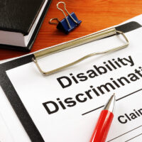 Disability Discrimination claim form and pen.
