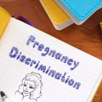 Business concept about Pregnancy Discrimination with sign on the sheet.