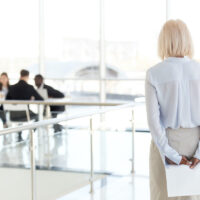 Rear view at stressed nervous senior businesswoman waiting for i