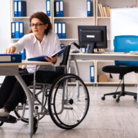 Female employee in wheel-chair at the office