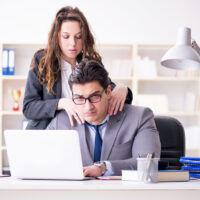 Sexual harassment concept with man and woman in office Sexual harassment concept with man and woman in office