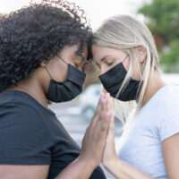 African and white northern women together and wearing protective face masks - Black lives matter concept - Girlfriends, love and no racism