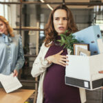 Glad colleague seeing off pregnant boss