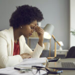 Frustrated african american woman keeping eyes closed and massaging nose