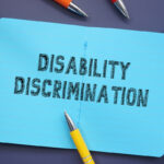 Business concept about Disability Discrimination with phrase on the sheet.