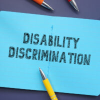 Business concept about Disability Discrimination with phrase on the sheet.