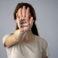 Stop sexual assault sign on womans hand, discrimination prevention, assault