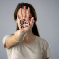 Stop sexual assault sign on womans hand, discrimination prevention, assault Stop sexual assault sign on womans hand, discrimination prevention, assault