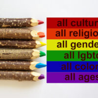 LGBT colors corrugated cardboard flag. Pencils lie on top Bright social colors lgbt. Diversity ethnicity gender age sexual orientation religion disability words. Copy space. Equality and diversity concept.