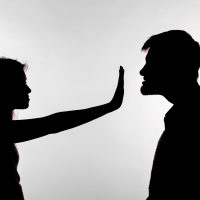 Man abusing woman, silhouette on a white background. Stop sexual assault Man abusing woman, silhouette on a white background. Stop sexual assault