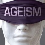 Ageism can blind our views and limit perspective - pictured as word Ageism on eyes to symbolize that Ageism can distort perception of the world, 3d illustration