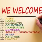 Hand writing 'we welcome', isolated on white background. Business concept. Copy space. Diversity ethnicity gender age sexual orientation religion disability words. Copy space. Equality and diversity concept.