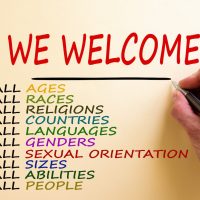 Hand writing 'we welcome', isolated on white background. Business concept. Copy space. Diversity ethnicity gender age sexual orientation religion disability words. Copy space. Equality and diversity concept. Hand writing 'we welcome', isolated on white background. Business concept. Copy space. Diversity ethnicity gender age sexual orientation religion disability words. Copy space. Equality and diversity concept.