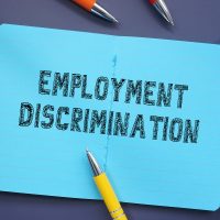Financial concept meaning Employment Discrimination with sign on the piece of paper.