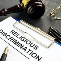 Religious Discrimination claim and pen on a table. Religious Discrimination claim and pen on a table.