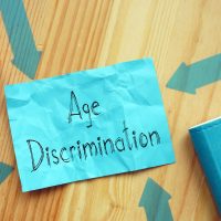 Age Discrimination is shown on the conceptual photo using the text