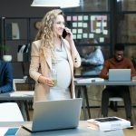 Businesswoman busy at work during pregnancy