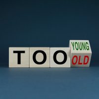 Cubes form words Too young or too old. Concept of age discrimination - social problem