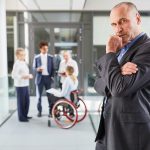Thoughtful manager with wheelchair users in the team Thoughtful manager with wheelchair users in the team