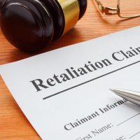 Retaliation claim lying on the desk with gavel. Retaliation claim lying on the desk with gavel.