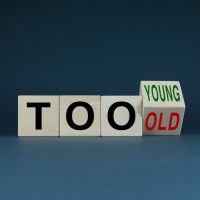 Cubes form words Too young or too old. Concept of age discrimination - social problem Cubes form words Too young or too old. Concept of age discrimination - social problem