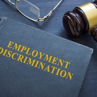 Law about employment discrimination and gavel on the table.