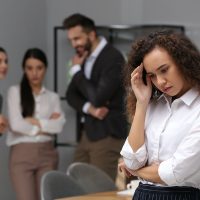 African American woman suffering from racial discrimination at work African American woman suffering from racial discrimination at work