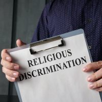 Papers about religious discrimination in the lawyer hands.