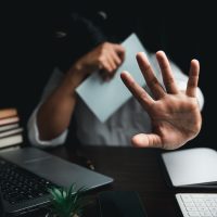 Stop harassment violence in workplace concept. Boss or employer sexually harassed a business woman at work. Depressed girl sitting in office. stop violence against Women, international women's day.