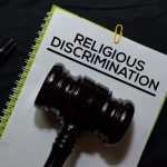 Religious Discrimination Document form and Black Judges gavel on office desk. Law concept