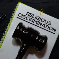 Religious Discrimination Document form and Black Judges gavel on office desk. Law concept