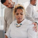 Sexual harassment, touch and uncomfortable with a business man putting a hand on the shoulder of a woman colleague. Exploitation, unprofessional and victimization with an employee touching a coworker.