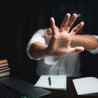 Stop harassment violence in workplace concept. Boss or employer sexually harassed a business woman at work. Depressed girl sitting in office. stop violence against Women, international women's day.