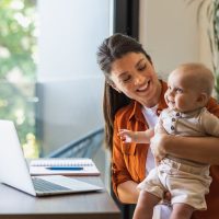 Shot of a young mother caring for her baby girl while working from home.