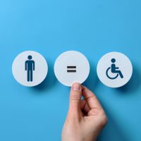 an image of an expensive person and a disabled person and an equal sign between them. Equality and acceptance of persons with disabilities