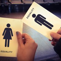 Woman and man equality paper in woman and man hand