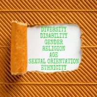 Diversity ethnicity gender age sexual orientation religion disability words written on white paper on a beautiful brown background. Equality diversity ethnicity gender disability concept.