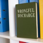 White shelf with book about wrongful discharge.