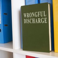 White shelf with book about wrongful discharge.