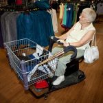 Senior woman shopping with a buggy
