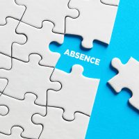 White puzzle pieces on a blue background with one piece missing. The word "ABSENCE" is visible in the gap, highlighting the concept of missing parts. White puzzle pieces on a blue background with one piece missing. The word "ABSENCE" is visible in the gap, highlighting the concept of missing parts.